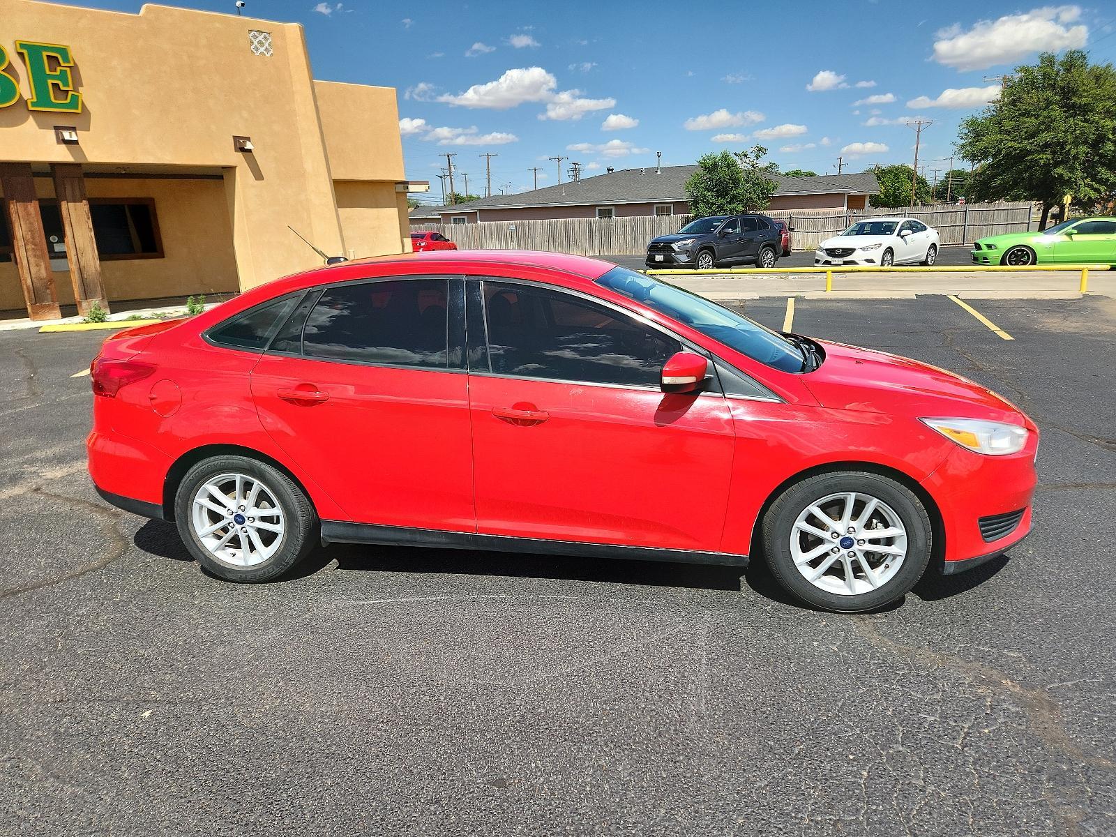 2017 Race Red /Charcoal Black Insert w/Warm Steel Surround, cloth Ford Focus SE (1FADP3F27HL) with an ENGINE: 2.0L I-4 GDI TI-VCT FLEX FUEL engine, located at 4711 Ave Q, Lubbock, TX, 79412, (806) 687-2362, 33.551304, -101.855293 - Photo #5