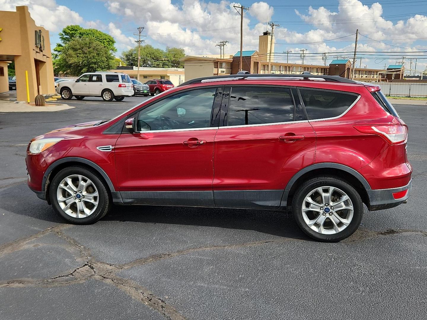 2013 Ruby Red Metallic Tinted Ford Escape SEL (1FMCU0H91DU) with an EcoBoost 2L I-4 gasoline direct injection, DOHC, variable valve control, intercooled turbo, regular unleaded, engine with 231HP engine, located at 4711 Ave Q, Lubbock, TX, 79412, (806) 687-2362, 33.551304, -101.855293 - Photo#1