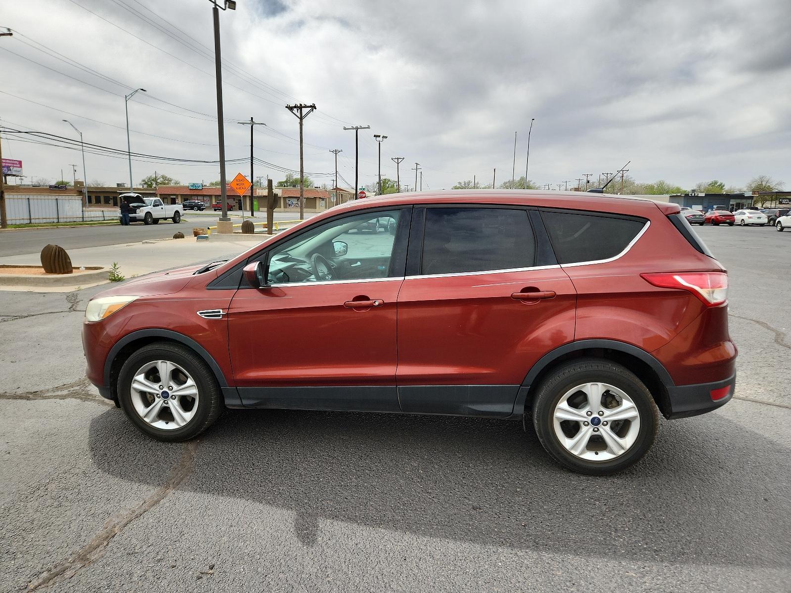 2014 Sunset /Charcoal Black Ford Escape SE (1FMCU0GX5EU) with an ENGINE: 1.6L ECOBOOST engine, located at 4711 Ave Q, Lubbock, TX, 79412, (806) 687-2362, 33.551304, -101.855293 - Photo #1