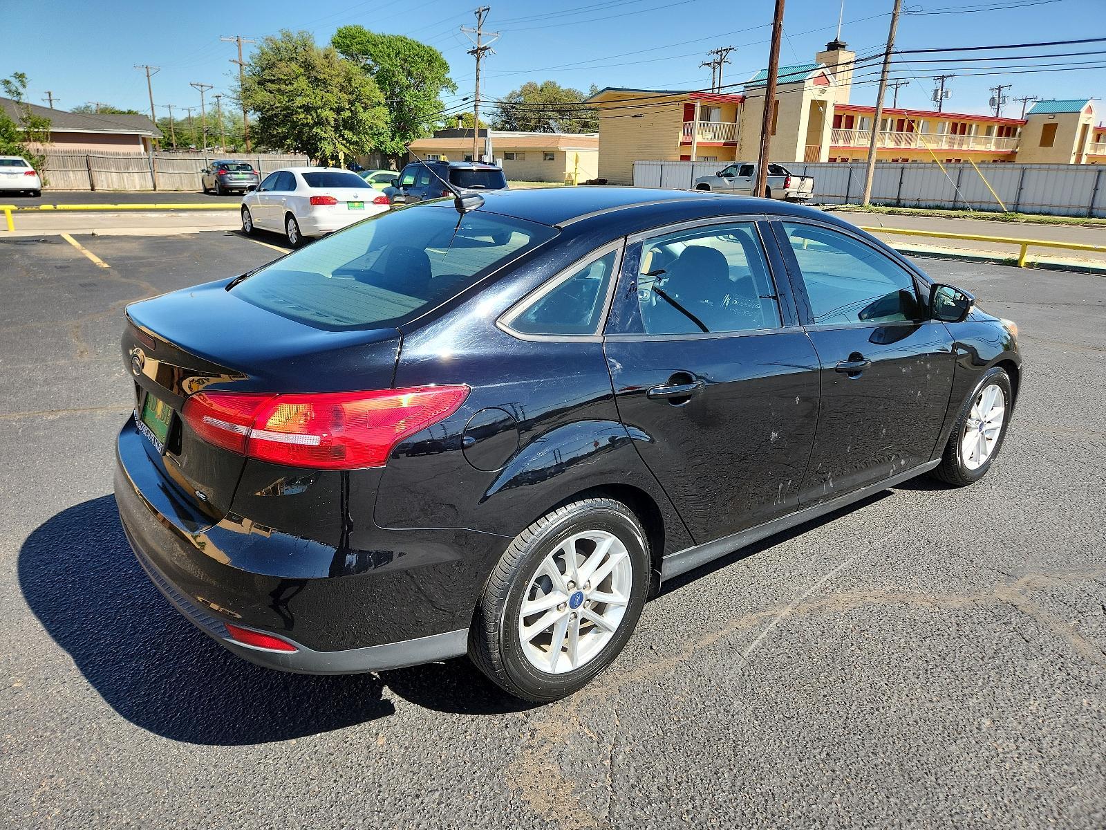 2017 Shadow Black /Charcoal Black Insert w/Warm Steel Surround, cloth Ford Focus SE (1FADP3F25HL) with an ENGINE: 2.0L I-4 GDI TI-VCT FLEX FUEL engine, located at 4711 Ave Q, Lubbock, TX, 79412, (806) 687-2362, 33.551304, -101.855293 - Photo #4