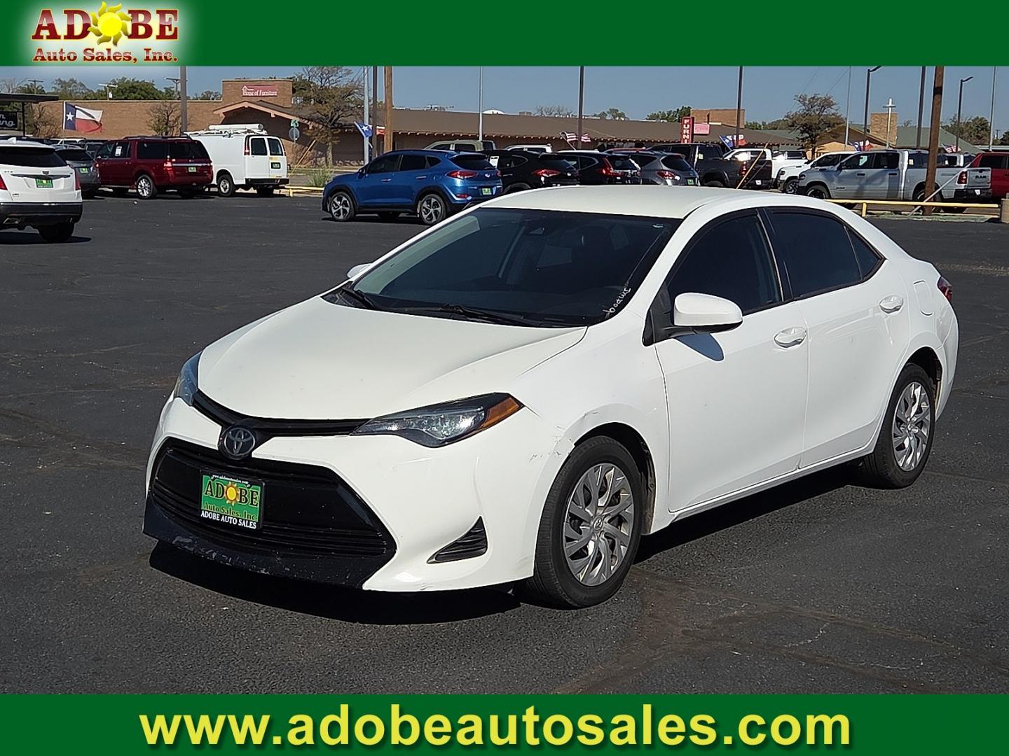 2019 Super White - 040 /Black - 21 Toyota Corolla LE (2T1BURHE5KC) with an 1.8L I-4 DOHC, VVT-i variable valve control, regular gasoline, engine with 132HP engine, located at 4711 Ave Q, Lubbock, TX, 79412, (806) 687-2362, 33.551304, -101.855293- Photo#0