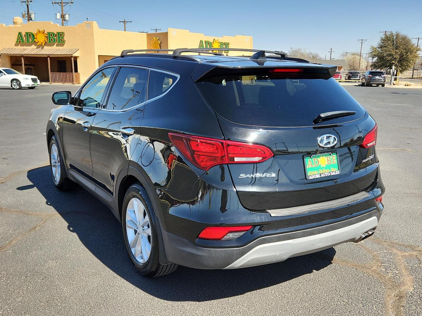 2018 Twilight Black Hyundai Santa Fe Sport 2.0T (5XYZU4LA5JG) with an Engine: 2.0L Turbo-GDI DOHC 16-Valve I4 engine, located at 4711 Ave Q, Lubbock, TX, 79412, (806) 687-2362, 33.551304, -101.855293 - Photo#2