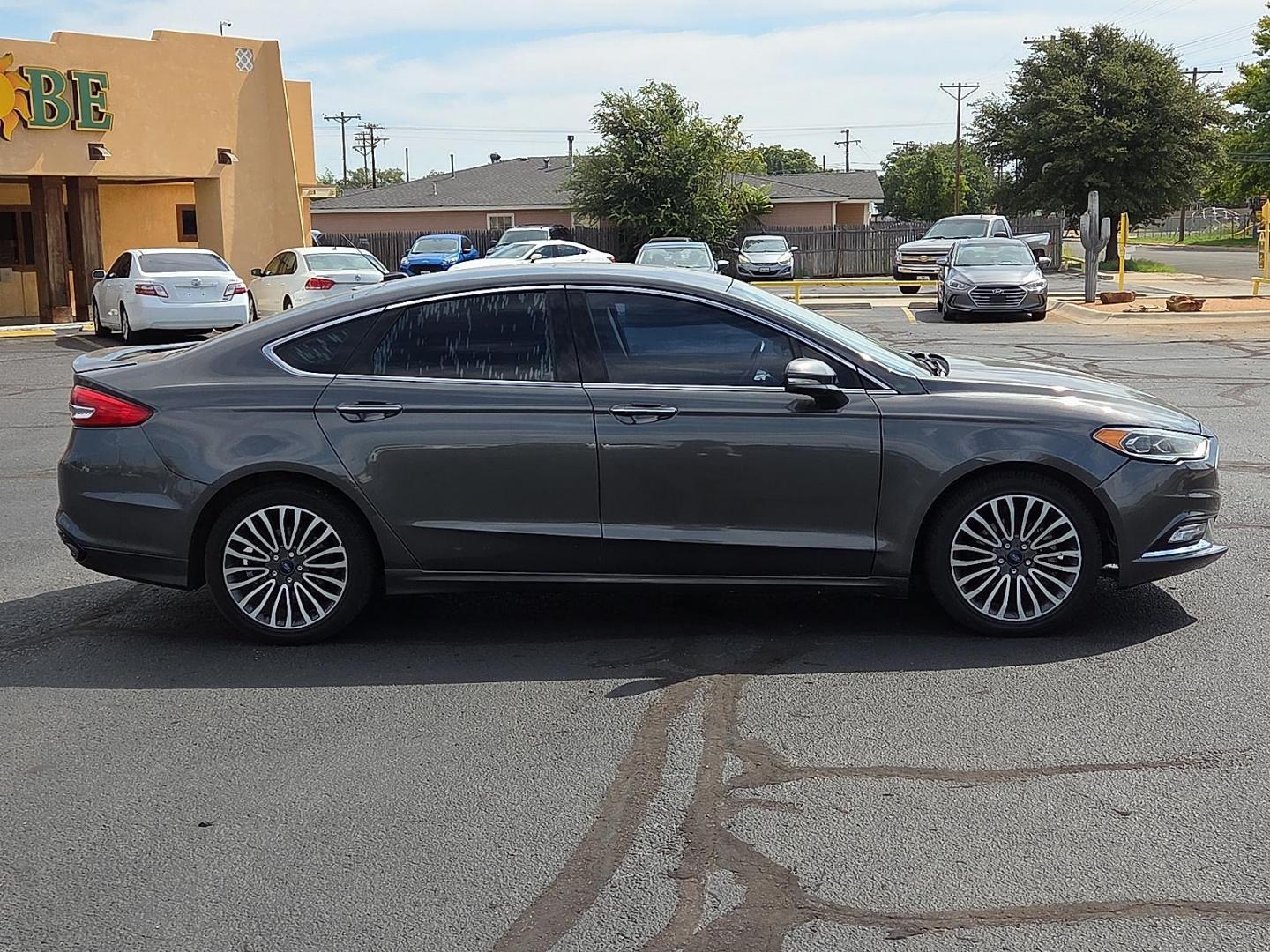 2018 Magnetic Metallic - J7 /Medium Soft Ceramic - CM Ford Fusion Titanium (3FA6P0D98JR) with an EcoBoost 2L I-4 gasoline direct injection, DOHC, variable valve control, intercooled turbo, regular unleaded, engine with 231HP engine, located at 4711 Ave Q, Lubbock, TX, 79412, (806) 687-2362, 33.551304, -101.855293 - Photo#5
