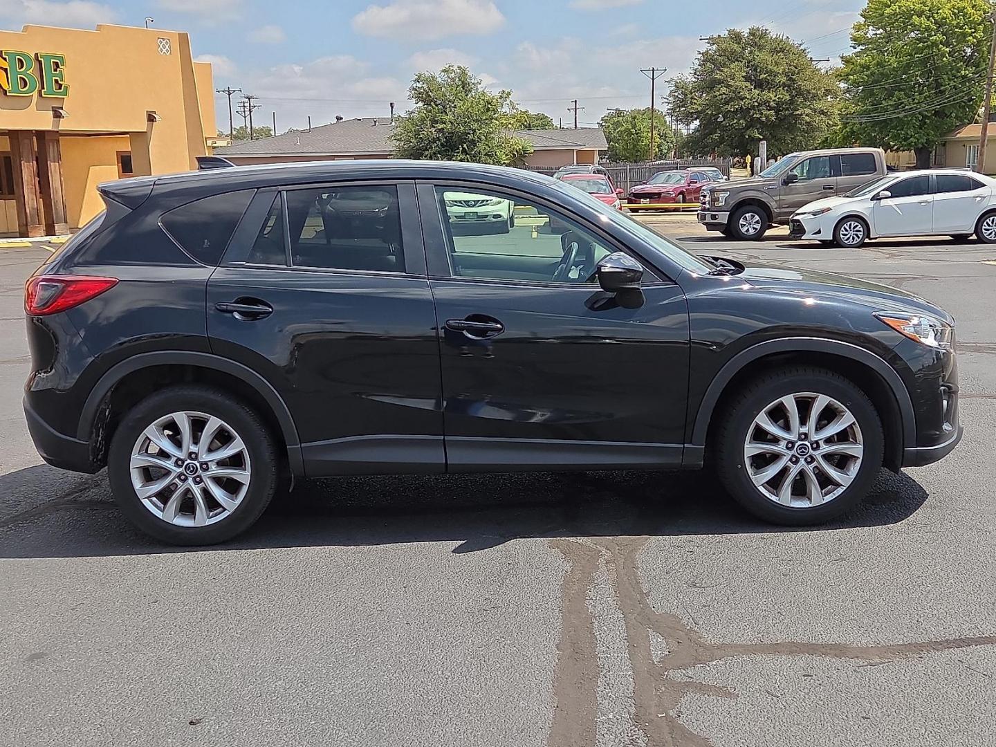2015 Deep Crystal Blue Mica - 42M /Sand - KC4 Mazda CX-5 Grand Touring (JM3KE2DY2F0) with an SKYACTIV-G 2.5L I-4 gasoline direct injection, DOHC, variable valve control, regular unleaded, engine with 184HP engine, located at 4711 Ave Q, Lubbock, TX, 79412, (806) 687-2362, 33.551304, -101.855293 - Photo#5