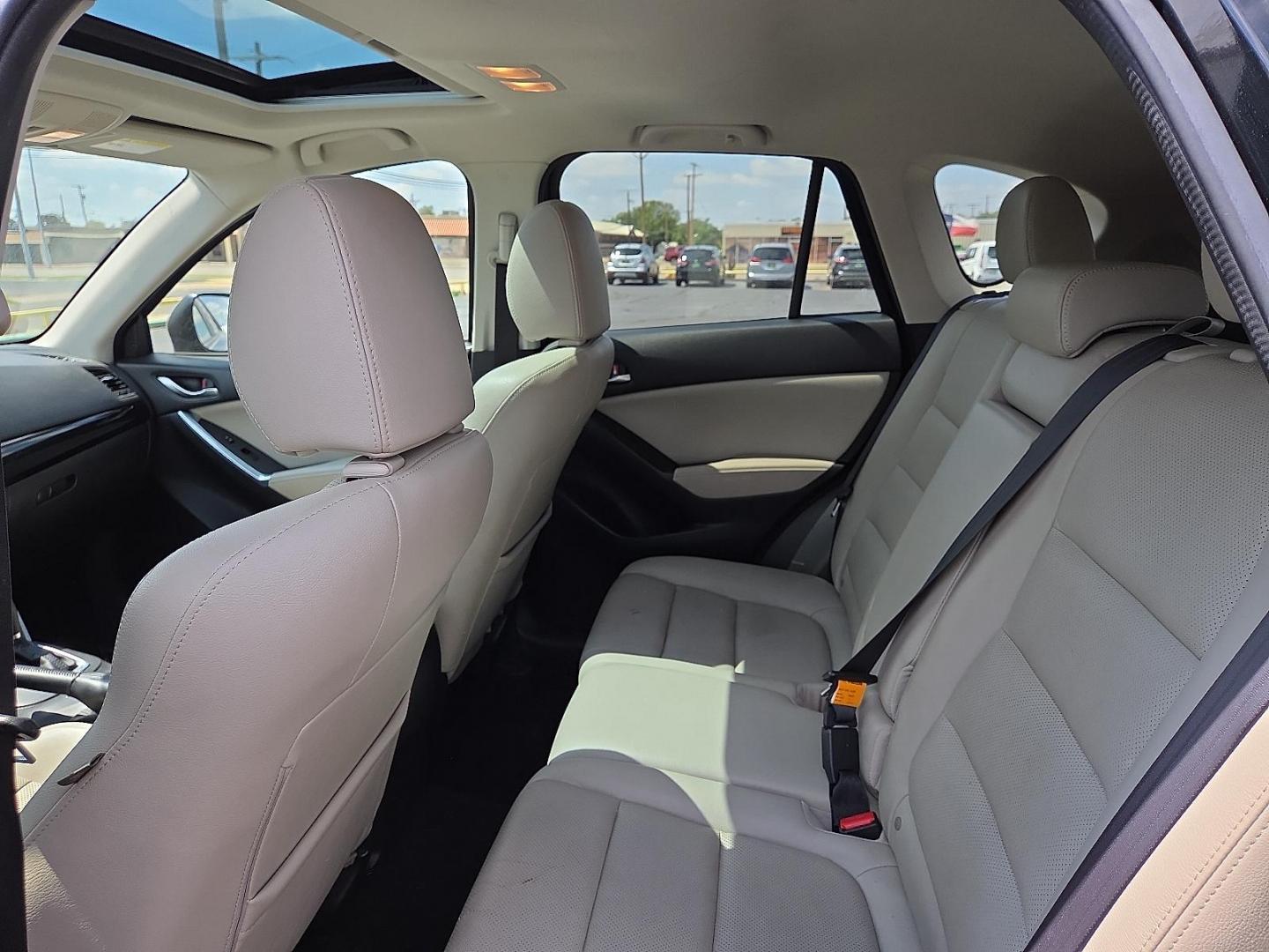 2015 Deep Crystal Blue Mica - 42M /Sand - KC4 Mazda CX-5 Grand Touring (JM3KE2DY2F0) with an SKYACTIV-G 2.5L I-4 gasoline direct injection, DOHC, variable valve control, regular unleaded, engine with 184HP engine, located at 4711 Ave Q, Lubbock, TX, 79412, (806) 687-2362, 33.551304, -101.855293 - Photo#16