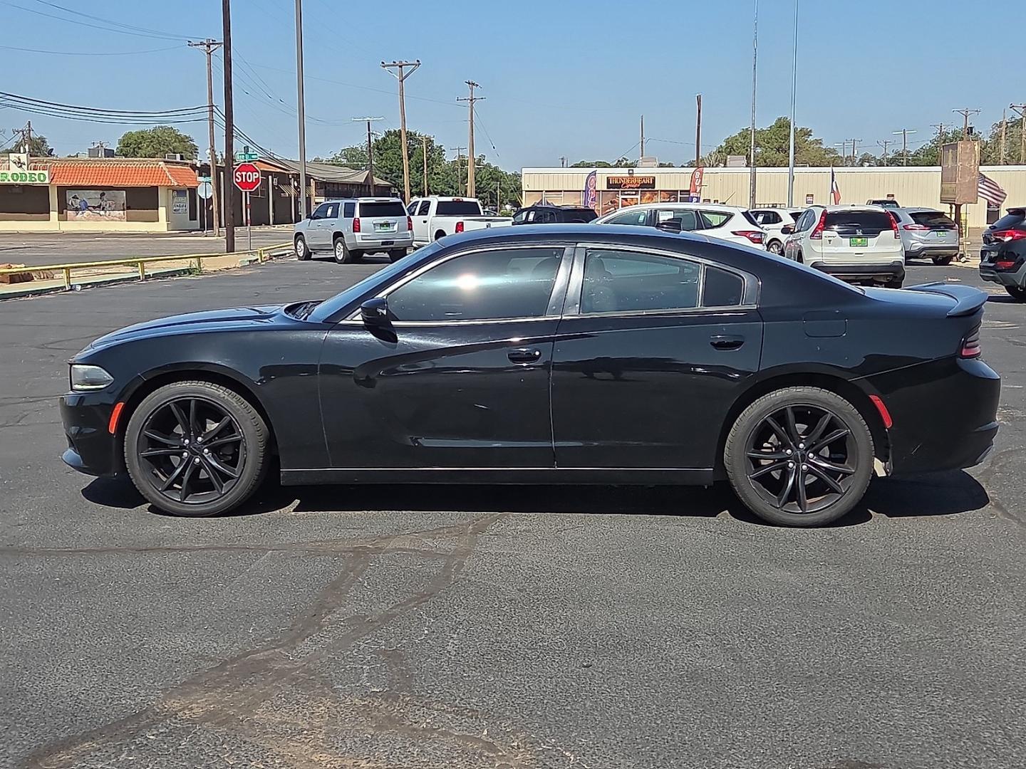 2016 Pitch Black Clearcoat - PX8 /Black - X9 Dodge Charger SXT (2C3CDXHG1GH) with an Pentastar 3.6L V-6 DOHC, variable valve control, regular unleaded, engine with 292HP engine, located at 4711 Ave Q, Lubbock, TX, 79412, (806) 687-2362, 33.551304, -101.855293- Photo#1