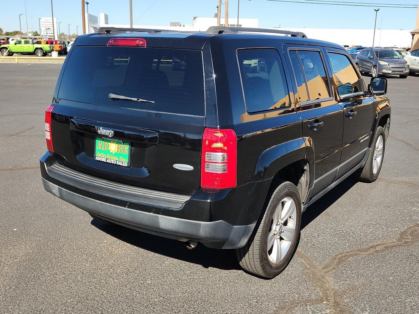 2012 BLACK Jeep Patriot Latitude (1C4NJPFB6CD) with an 2.4L I-4 DOHC, variable valve control, regular unleaded, engine with 172HP engine, located at 4711 Ave Q, Lubbock, TX, 79412, (806) 687-2362, 33.551304, -101.855293 - Photo#3