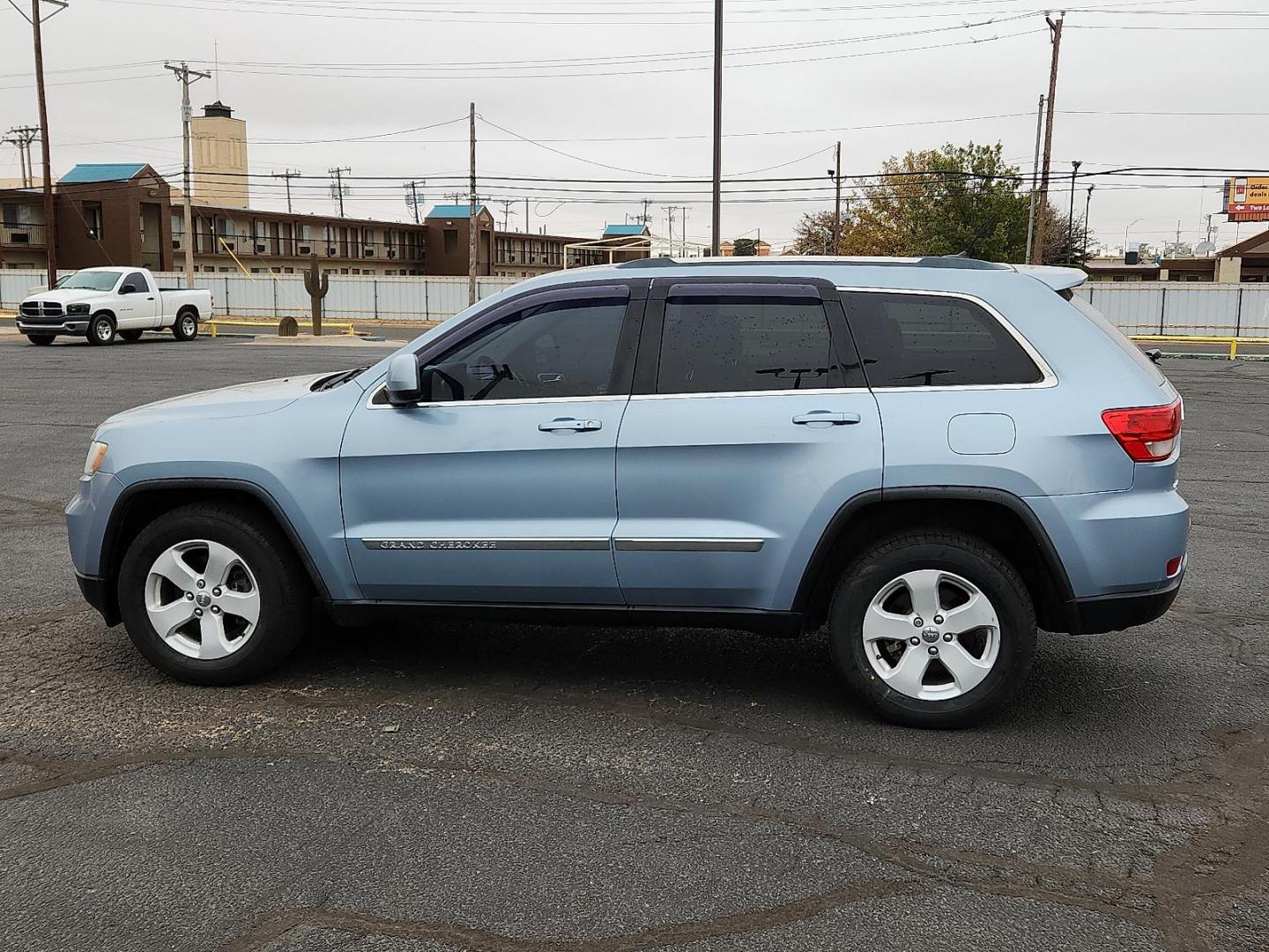 2013 BLUE Jeep Grand Cherokee Laredo (1C4RJFAT7DC) with an HEMI 5.7L V-8 variable valve control, regular unleaded, engine with cylinder deactivation and 360HP engine, located at 4711 Ave Q, Lubbock, TX, 79412, (806) 687-2362, 33.551304, -101.855293 - Photo#1