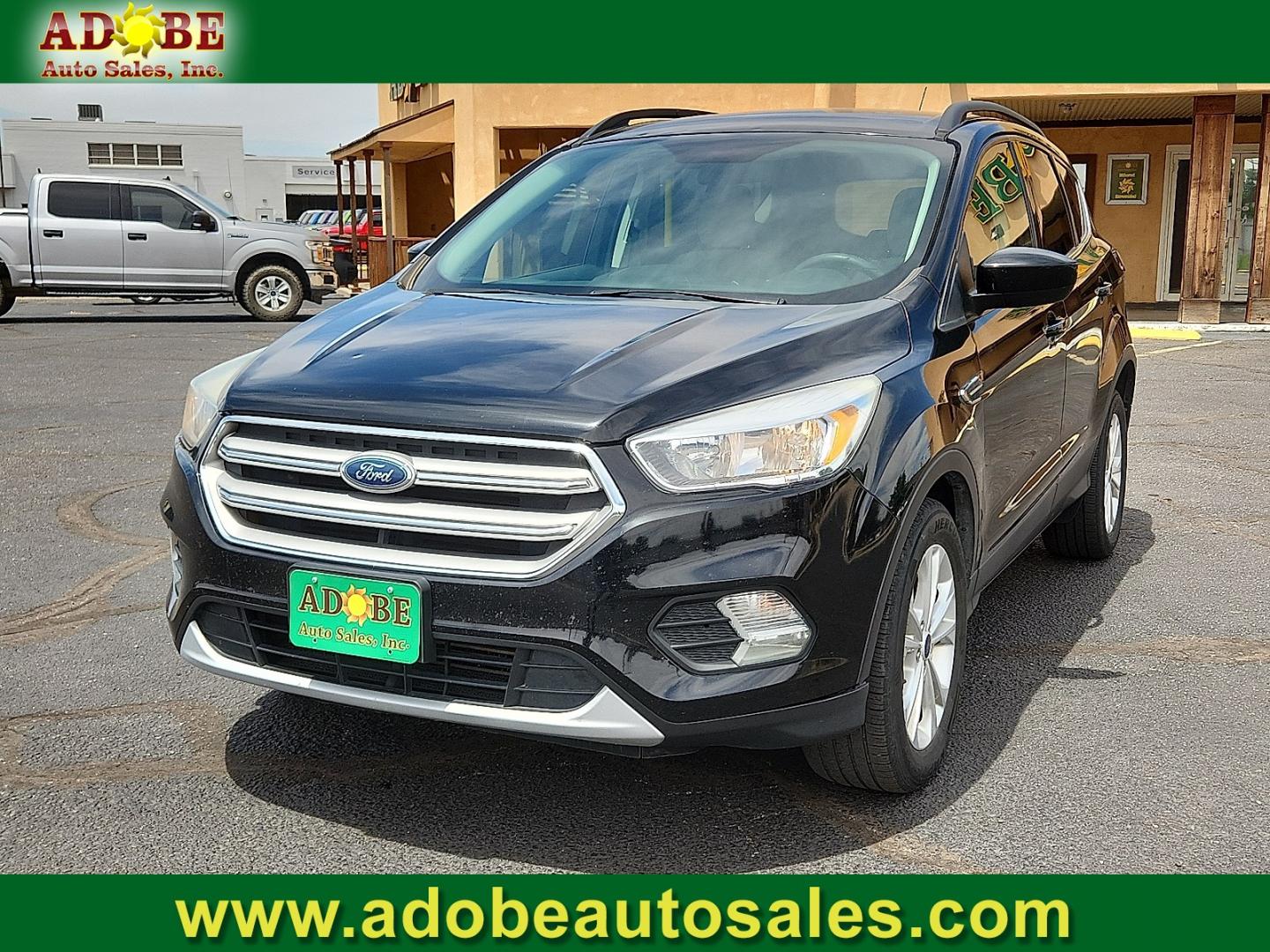 2018 BLACK /Medium Light Stone - KL Ford Escape SE (1FMCU0G9XJU) with an EcoBoost 2L I-4 gasoline direct injection, DOHC, variable valve control, intercooled turbo, premium unleaded, engine with 245HP engine, located at 4711 Ave Q, Lubbock, TX, 79412, (806) 687-2362, 33.551304, -101.855293- Photo#0
